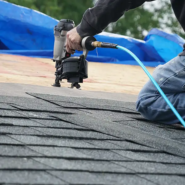 Roofer installing new shingles